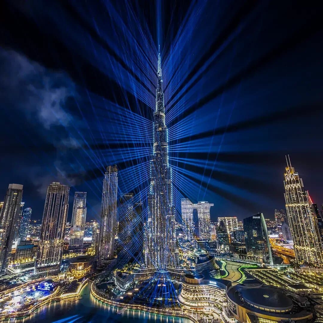 The Burj Khalifa lit at night above the Dubai skyline