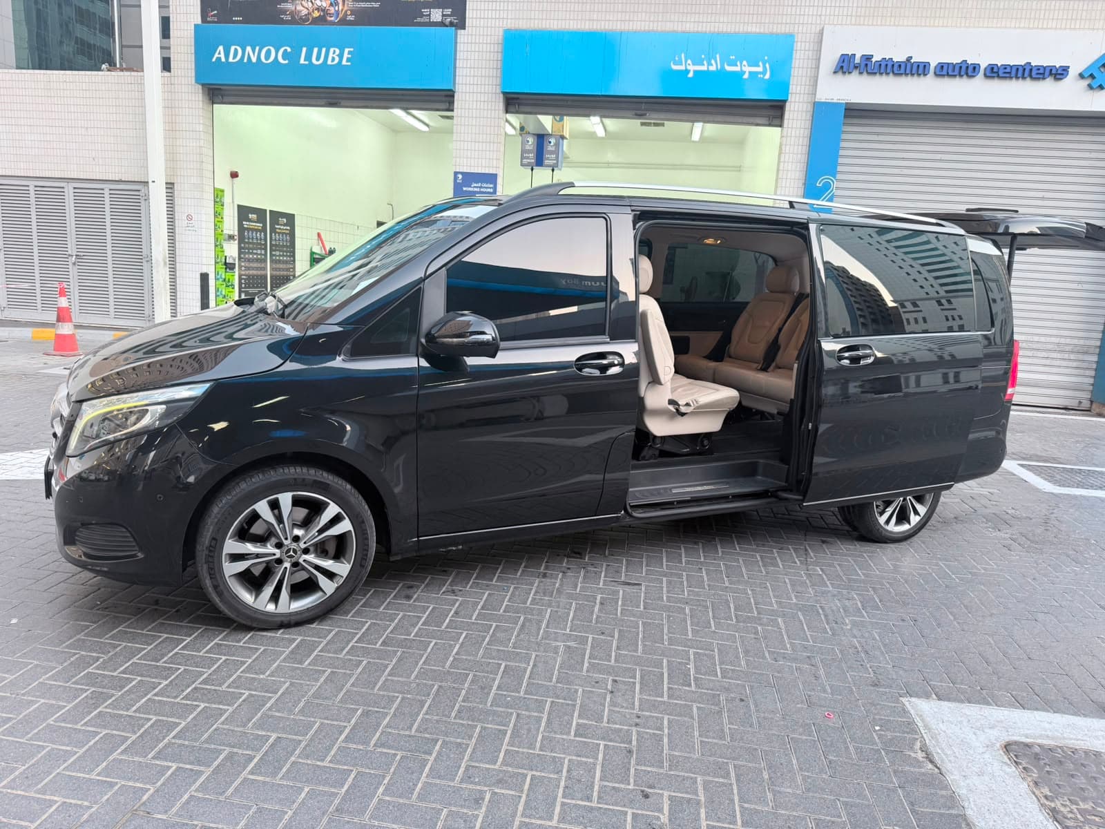 The sliding door open on the beige leather cabin, ready to board