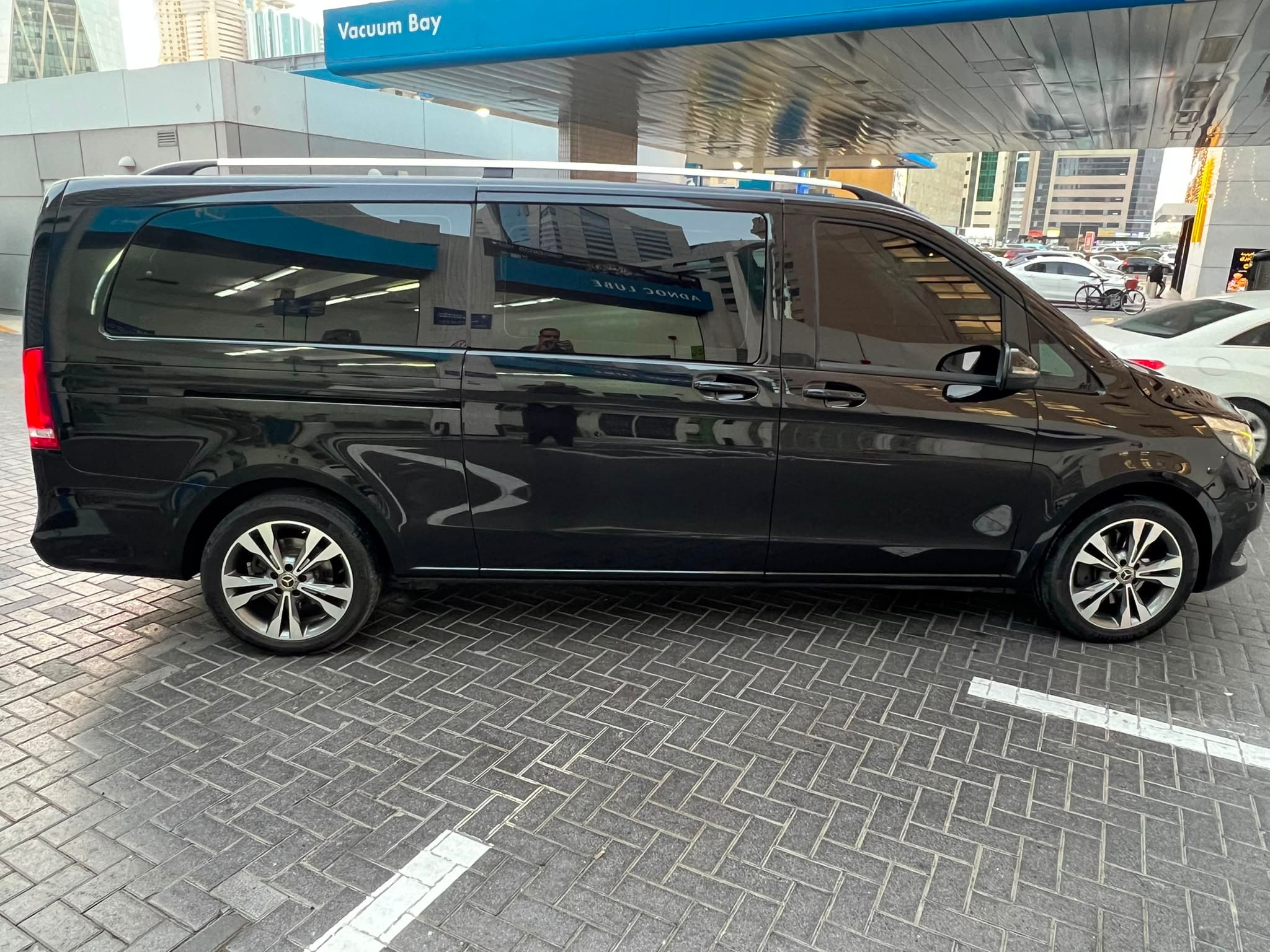 The black Mercedes V-Class in profile, showing its full length