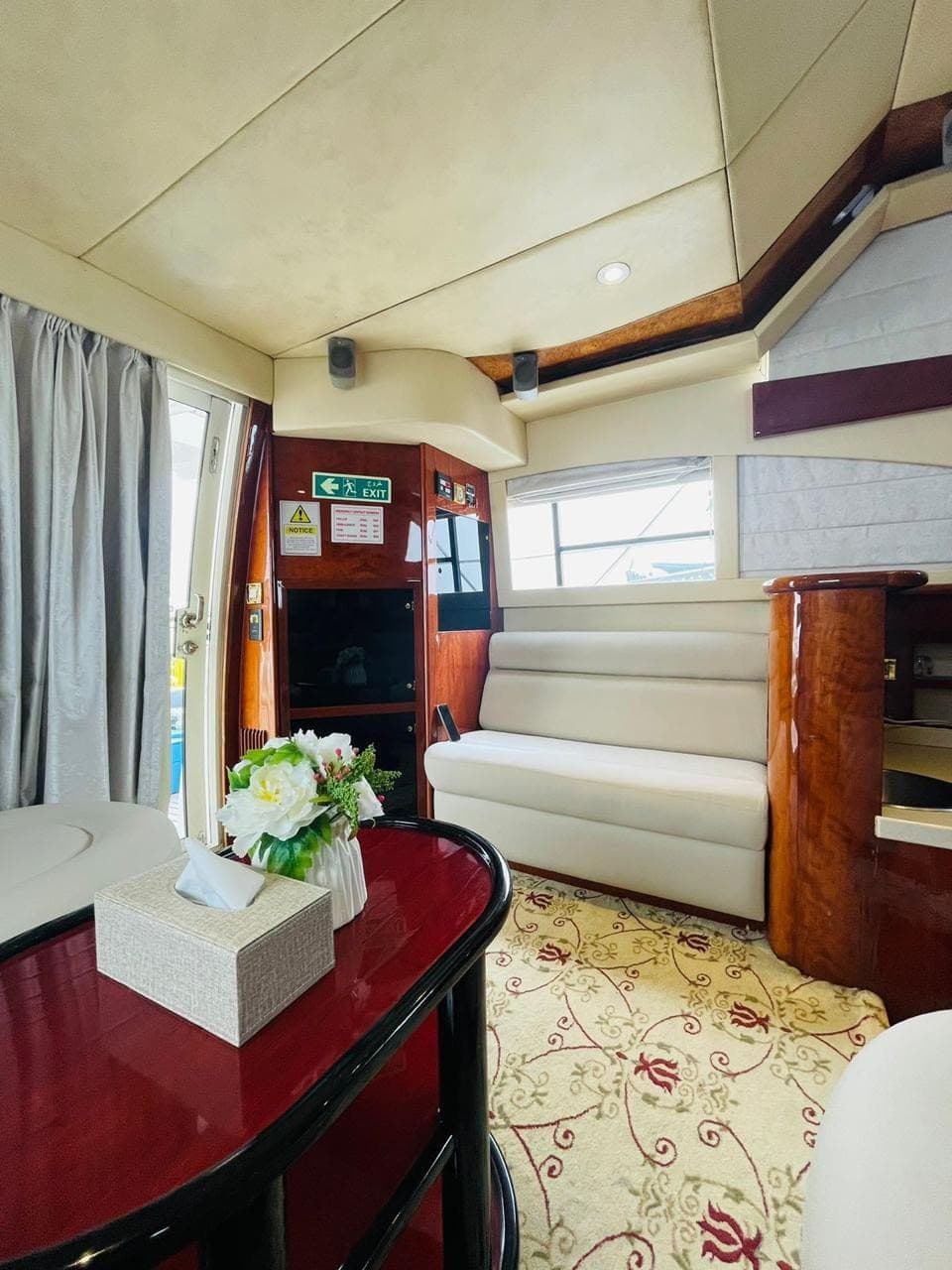 The saloon looking aft, with bench seating and the door out to the deck