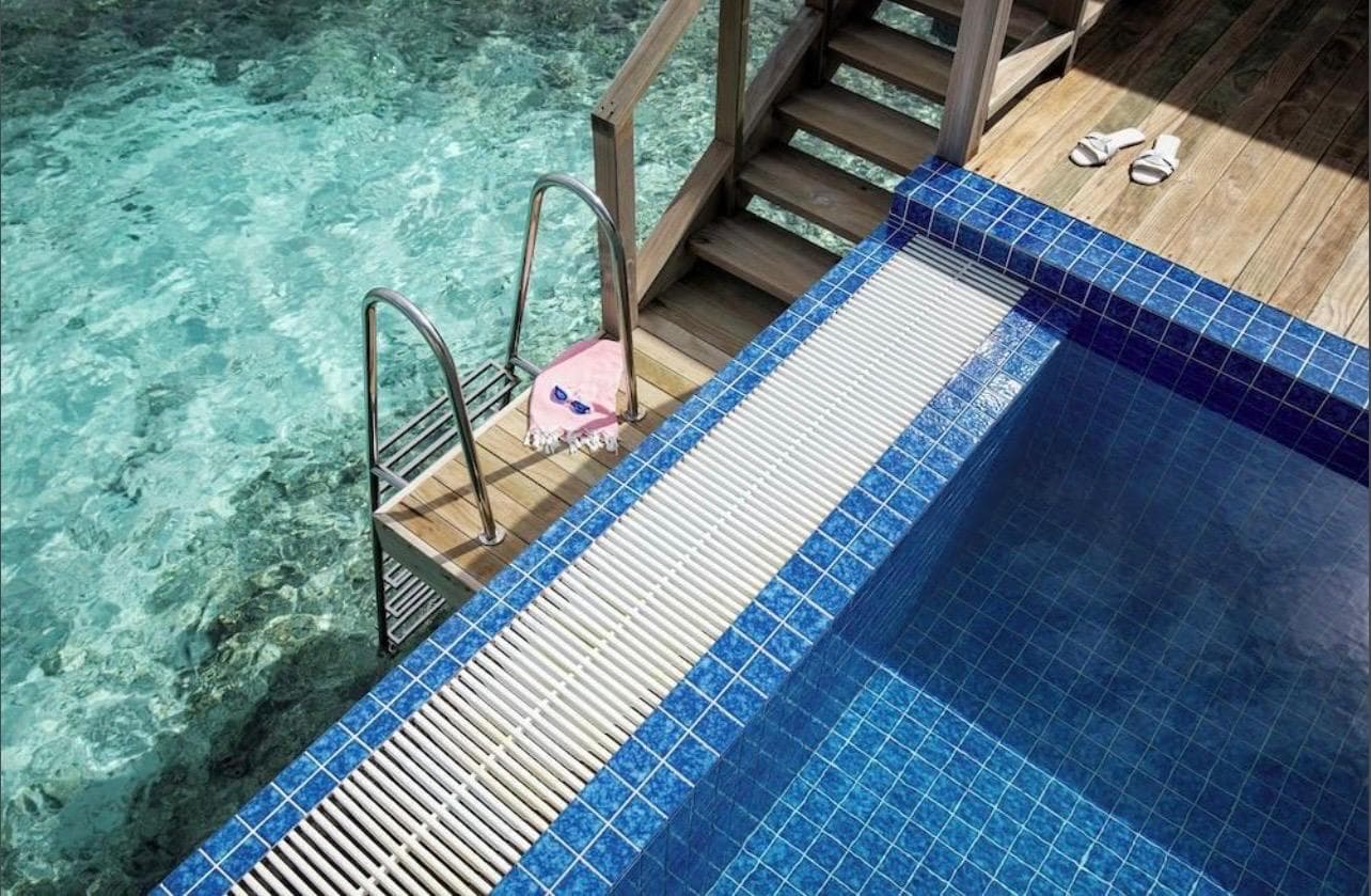 Steps from the deck into water clear enough to see the reef below