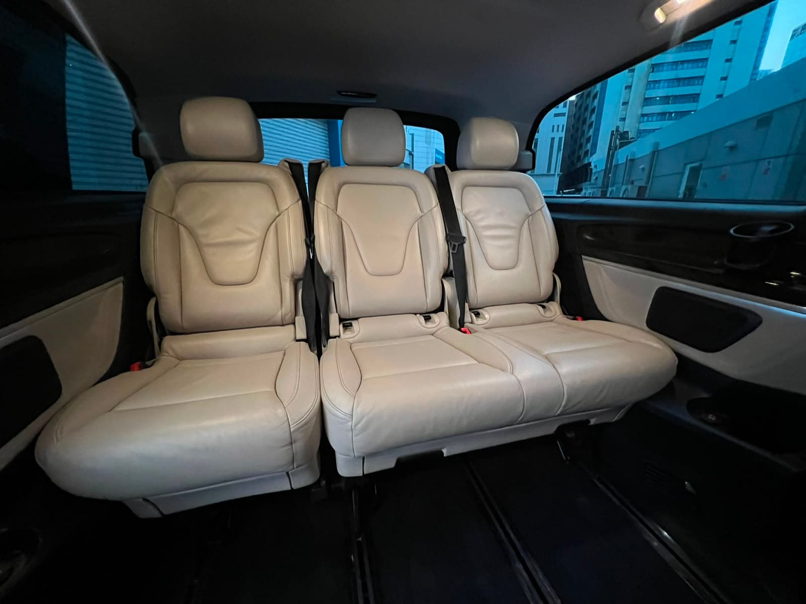 The rear bench in beige leather, three seats across